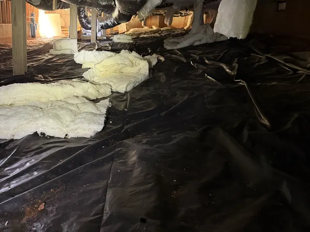 Insulation batts fallen out of the floor joists onto the crawl space plastic