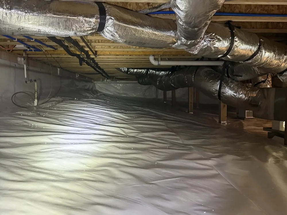 Insulated ductwork over a finished white crawl space liner