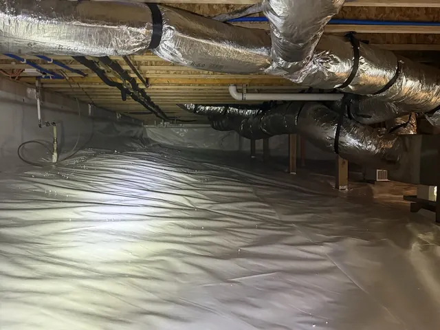 Insulated ductwork over a finished white crawl space liner